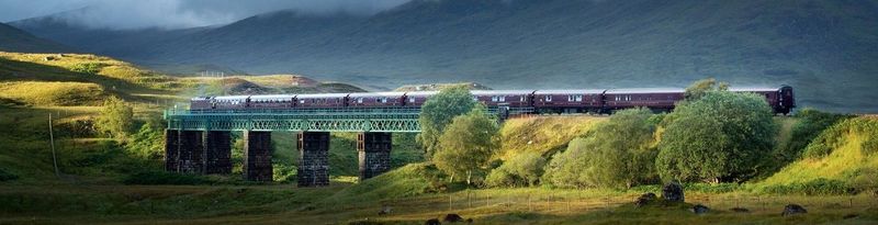 The Royal Scotsman luxury train crossing a viaduct in Scotland